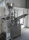 Used Comadis C-125 Plastic and Metal Tube Filler, rotary valve piston tube filler