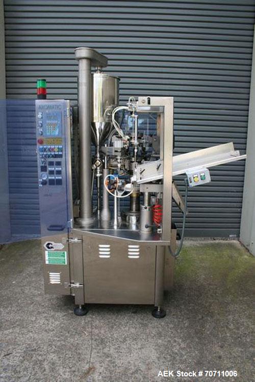 Used Axiomatic Model Optima 700 Axomatic Tube Filler. 7 Station, water cooled hot jaws, hopper with agitator, maximum speed of 2,500 pieces/hour, automatic tube positioning, fixed nozzle with bush-ra...