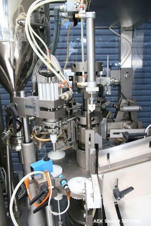 Used Axiomatic Model Optima 700 Axomatic Tube Filler. 7 Station, water cooled hot jaws, hopper with agitator, maximum speed of 2,500 pieces/hour, automatic tube positioning, fixed nozzle with bush-ra...