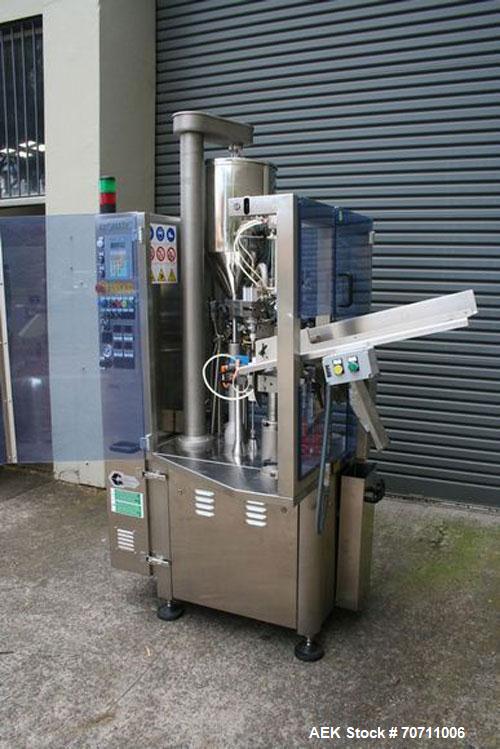Used Axiomatic Model Optima 700 Axomatic Tube Filler. 7 Station, water cooled hot jaws, hopper with agitator, maximum speed of 2,500 pieces/hour, automatic tube positioning, fixed nozzle with bush-ra...