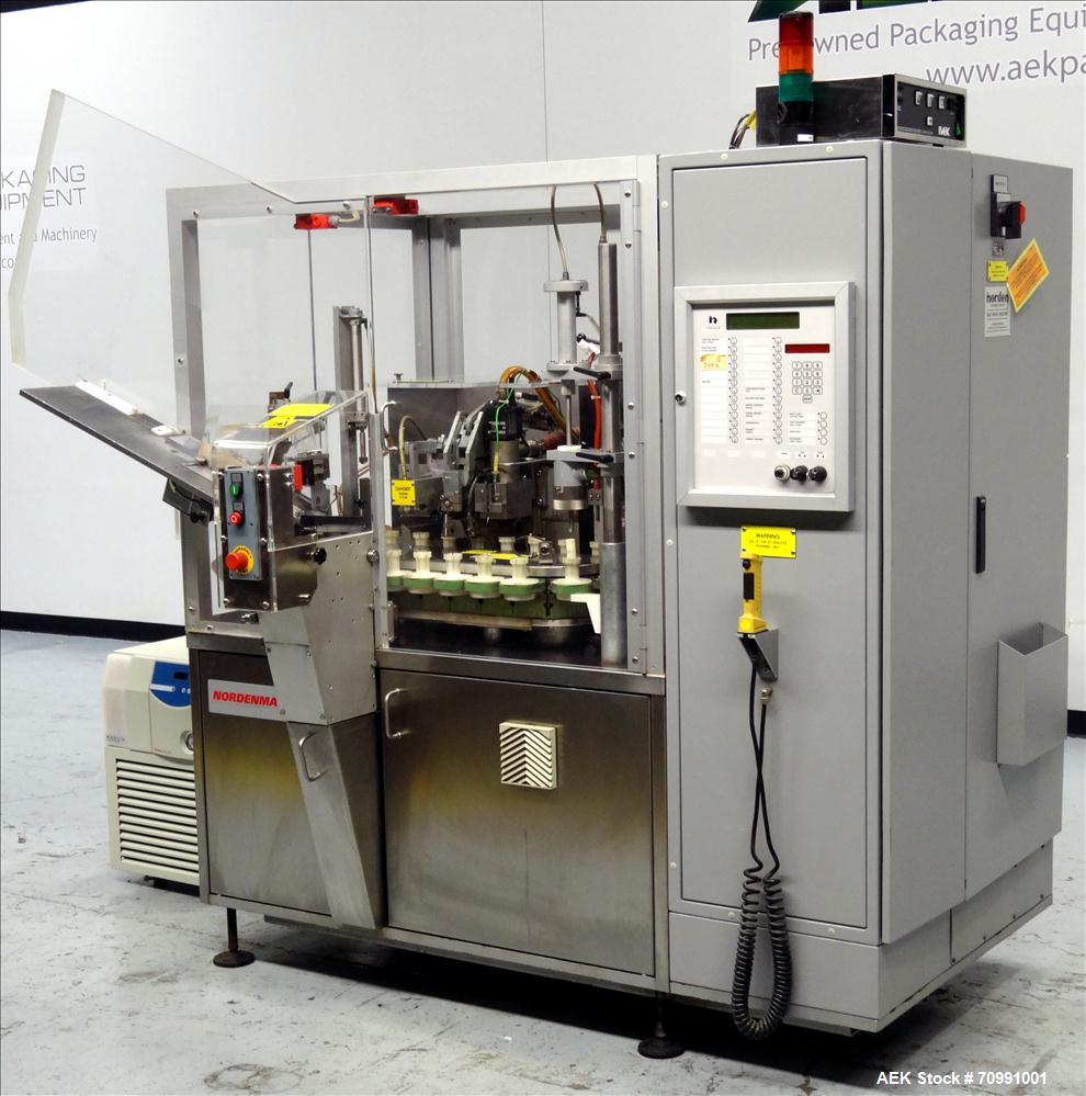 Used Norden Model NM 700 HA Hot Air Plastic Tube Filler. Capable of speeds up to 70 tubes per minute. General Fill volume range: 1ml - 300ml. Tube size range: (Length) 50mm - 250mm (Diam) 10mm - 60mm...