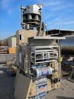 Used Transwrap Model S-750 Vertical Form Fill and Seal Machine. Includes top-mounted volumetric feeder. Has a 24