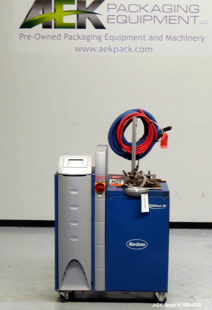 Used Nordson VersaBlue 50 Glue System. Built 2004. Has a holding capacity of 50 Liters, Maximum 6 hoses/guns, throughput per hour 165 lbs (75kg), Melt Rate per hour 110 lbs (50kg). 3/230V/50/60HZ. Ha...