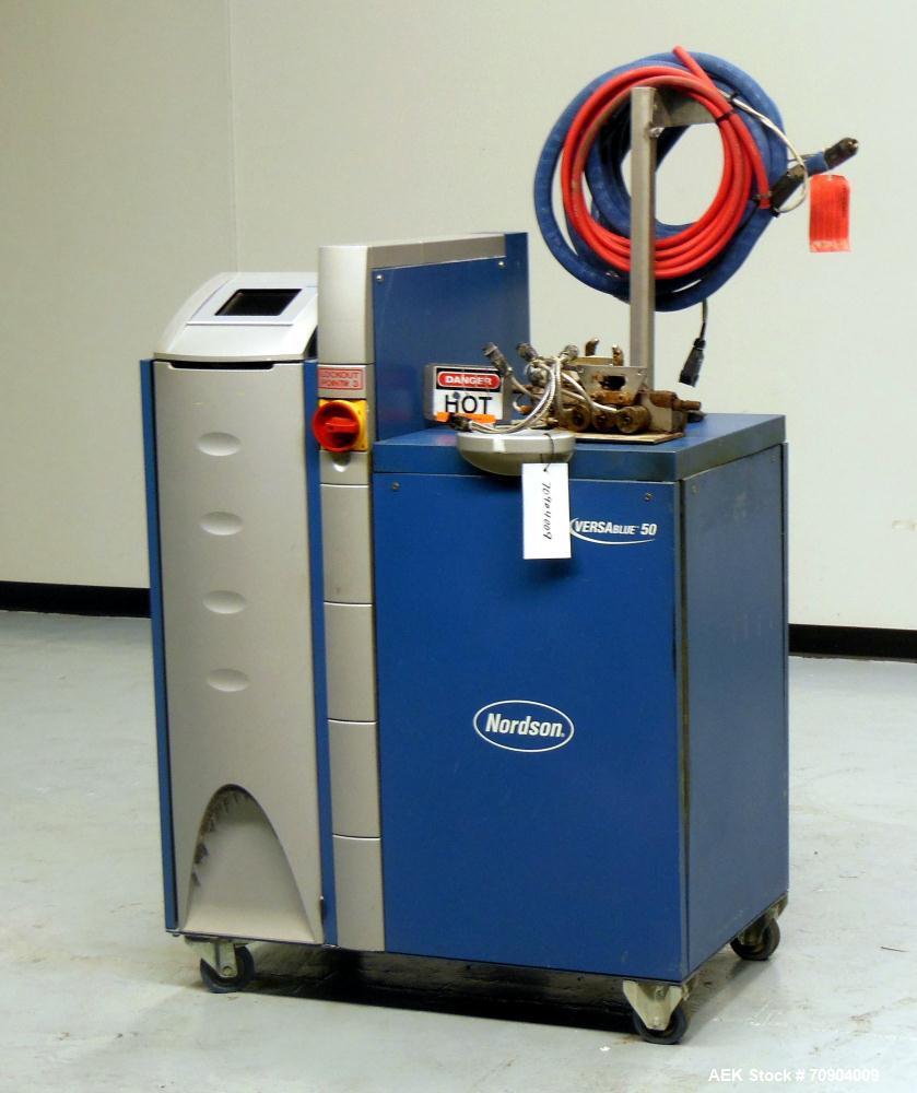 Used Nordson VersaBlue 50 Glue System. Built 2004. Has a holding capacity of 50 Liters, Maximum 6 hoses/guns, throughput per hour 165 lbs (75kg), Melt Rate per hour 110 lbs (50kg). 3/230V/50/60HZ. Ha...