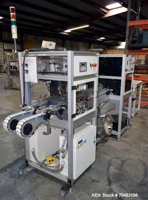 Used PVA (Halfmoon NY) Glue Applicator, serial #C1055, with cooling section. Features twin Rexroth 2” table top chain conveyors which introduce bottle to glue nozzles, then manual “shell/cap” placing...