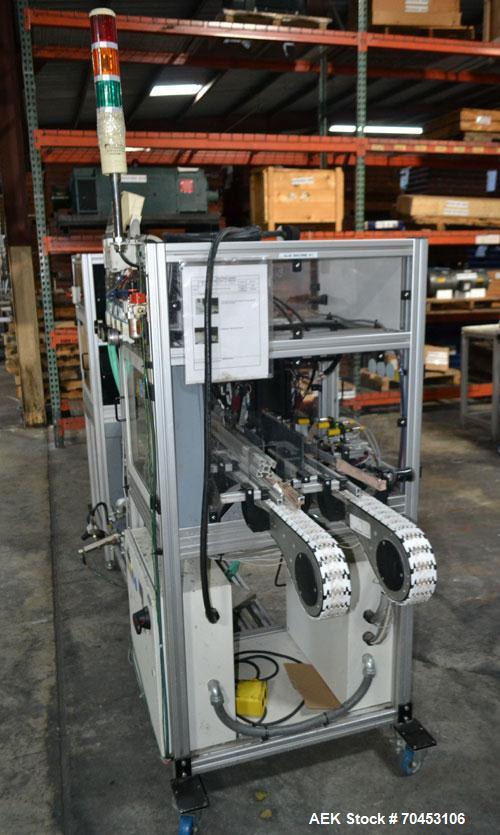 Used PVA (Halfmoon NY) Glue Applicator, serial #C1055, with cooling section. Features twin Rexroth 2” table top chain conveyors which introduce bottle to glue nozzles, then manual “shell/cap” placing...