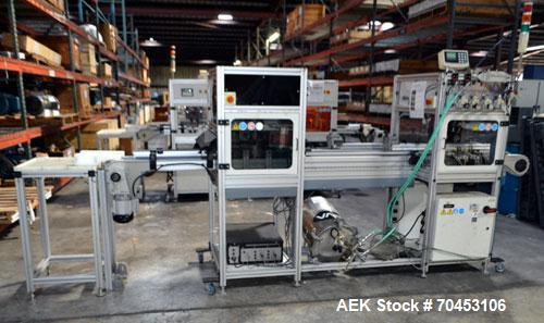 Used PVA (Halfmoon NY) Glue Applicator, serial #C1055, with cooling section. Features twin Rexroth 2” table top chain conveyors which introduce bottle to glue nozzles, then manual “shell/cap” placing...