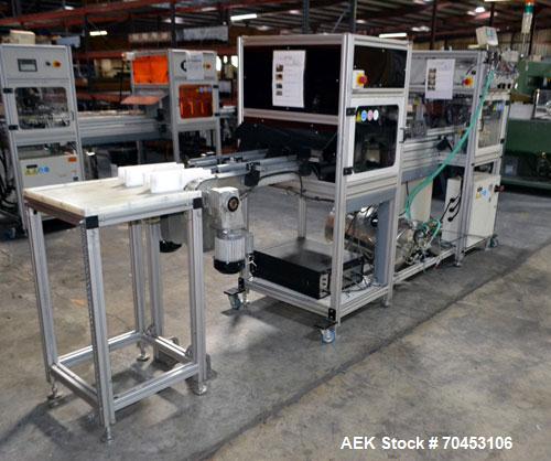 Used PVA (Halfmoon NY) Glue Applicator, serial #C1055, with cooling section. Features twin Rexroth 2” table top chain conveyors which introduce bottle to glue nozzles, then manual “shell/cap” placing...