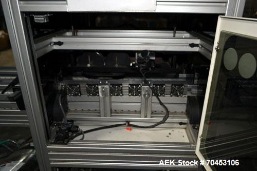 Used PVA (Halfmoon NY) Glue Applicator, serial #C1055, with cooling section. Features twin Rexroth 2” table top chain conveyors which introduce bottle to glue nozzles, then manual “shell/cap” placing...
