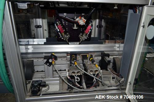 Used PVA (Halfmoon NY) Glue Applicator, serial #C1055, with cooling section. Features twin Rexroth 2” table top chain conveyors which introduce bottle to glue nozzles, then manual “shell/cap” placing...