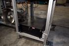 Used PVA (Halfmoon NY) Glue Applicator, serial #C1055, with cooling section. Features twin Rexroth 2” table top chain conveyors which introduce bottle to glue nozzles, then manual “shell/cap” placing...