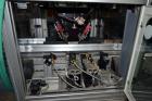 Used PVA (Halfmoon NY) Glue Applicator, serial #C1055, with cooling section. Features twin Rexroth 2” table top chain conveyors which introduce bottle to glue nozzles, then manual “shell/cap” placing...