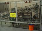 Used NewWay Roll Through Glue Wraparound Labeler, Model E5C5B. Capable of speeds up to 500 cpm. Will label metal cans, jars, plastic bottles or composite cans. Container size range: diameter 1.75