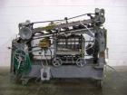 Used NewWay Roll Through Glue Wraparound Labeler, Model E5C5B. Capable of speeds up to 500 cpm. Will label metal cans, jars, plastic bottles or composite cans. Container size range: diameter 1.75