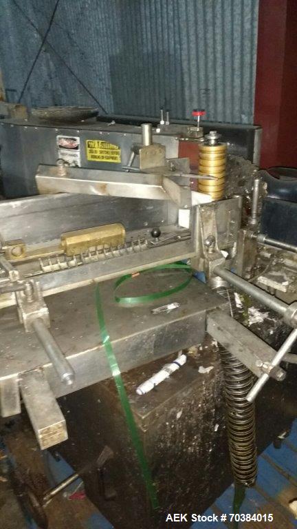 Used Krones Single Head Paper Labeler, Model Rotina. Infeed and discharge conveyor. 220/440 Volt.  Last doing gallon bottles.  Mfg. 1997.