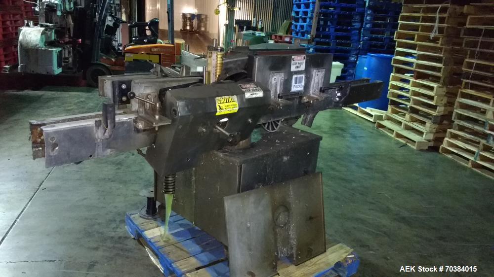 Used Krones Single Head Paper Labeler, Model Rotina. Infeed and discharge conveyor. 220/440 Volt.  Last doing gallon bottles.  Mfg. 1997.