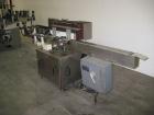 Used Krones Rotina I Wraparound Cold Glue Labeler. Cable of speeds up to 80 bottles per minute on wraparound or 100 bottles per minute on spot labels. Has a label size range: length 2
