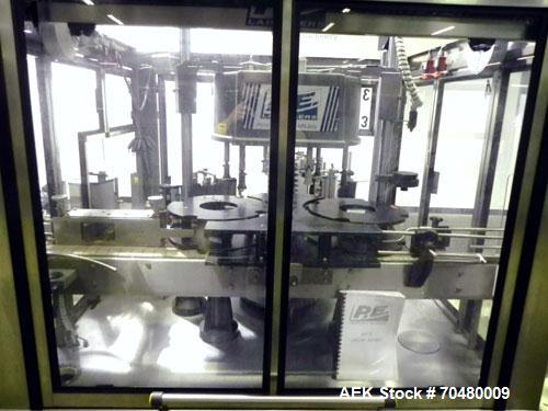 Used P.E. Labellers Six Head Rotary Labeler Model Master M With Dual Model M60 DX 150 Labelling Heads. Capable of Running Front and Back or Wraparound Pressure Sensitive Labels. Six (6) Bottle Plates...