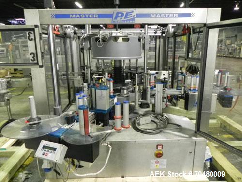Used P.E. Labellers Six Head Rotary Labeler Model Master M With Dual Model M60 DX 150 Labelling Heads. Capable of Running Front and Back or Wraparound Pressure Sensitive Labels. Six (6) Bottle Plates...