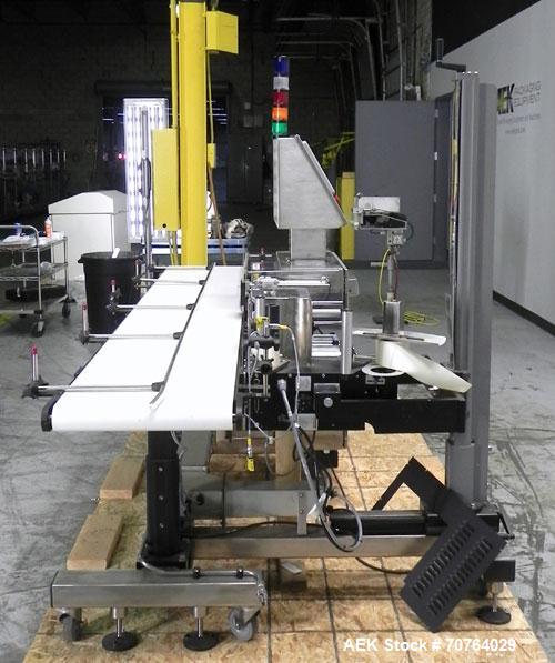 Used Paragon Model PLS-400 Print & Apply Case Labeler. Designed to print barcode and RFID labels. Machine has a 7” Tall label head. Includes automatic belt type case conveyor, integrated on common fr...