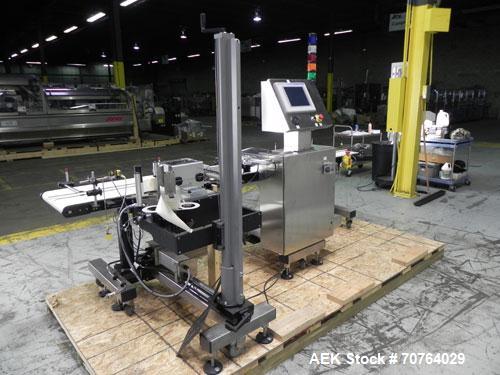 Used Paragon Model PLS-400 Print & Apply Case Labeler. Designed to print barcode and RFID labels. Machine has a 7” Tall label head. Includes automatic belt type case conveyor, integrated on common fr...