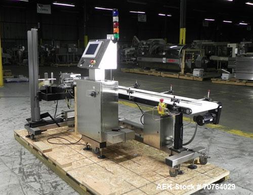 Used Paragon Model PLS-400 Print & Apply Case Labeler. Designed to print barcode and RFID labels. Machine has a 7” Tall label head. Includes automatic belt type case conveyor, integrated on common fr...