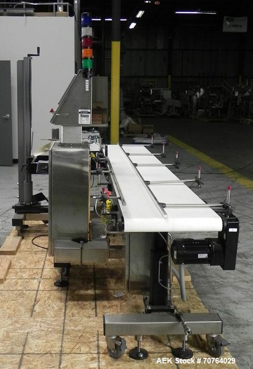 Used Paragon Model PLS-400 Print & Apply Case Labeler. Designed to print barcode and RFID labels. Machine has a 7” Tall label head. Includes automatic belt type case conveyor, integrated on common fr...