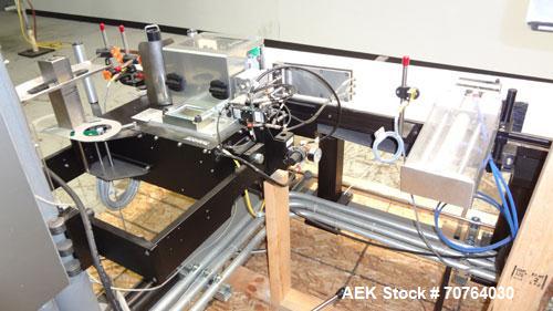 Used Paragon Model PLS-400 Print & Apply Case Labeler. Designed to print barcode and RFID labels using a Datamax DMX-A-4212 Print engine . Machine has a 7” Tall label head. Includes automatic belt ty...