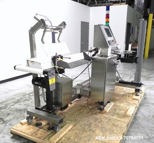 Used Paragon Model PLS-400 Print & Apply Case Labeler. Designed to print barcode and RFID labels. Machine has a 7” Tall label head. Includes automatic belt type case conveyor, integrated on common fr...