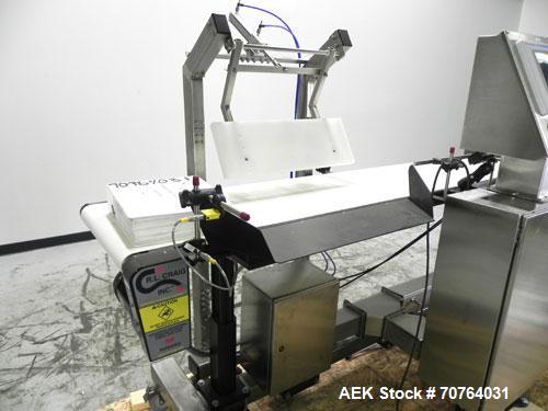 Used Paragon Model PLS-400 Print & Apply Case Labeler. Designed to print barcode and RFID labels. Machine has a 7” Tall label head. Includes automatic belt type case conveyor, integrated on common fr...