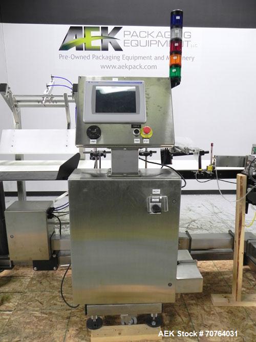 Used Paragon Model PLS-400 Print & Apply Case Labeler. Designed to print barcode and RFID labels. Machine has a 7” Tall label head. Includes automatic belt type case conveyor, integrated on common fr...