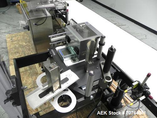 Used Paragon Model PLS-400 Print & Apply Case Labeler. Designed to print barcode and RFID labels. Machine has a 7” Tall label head. Includes automatic belt type case conveyor, integrated on common fr...