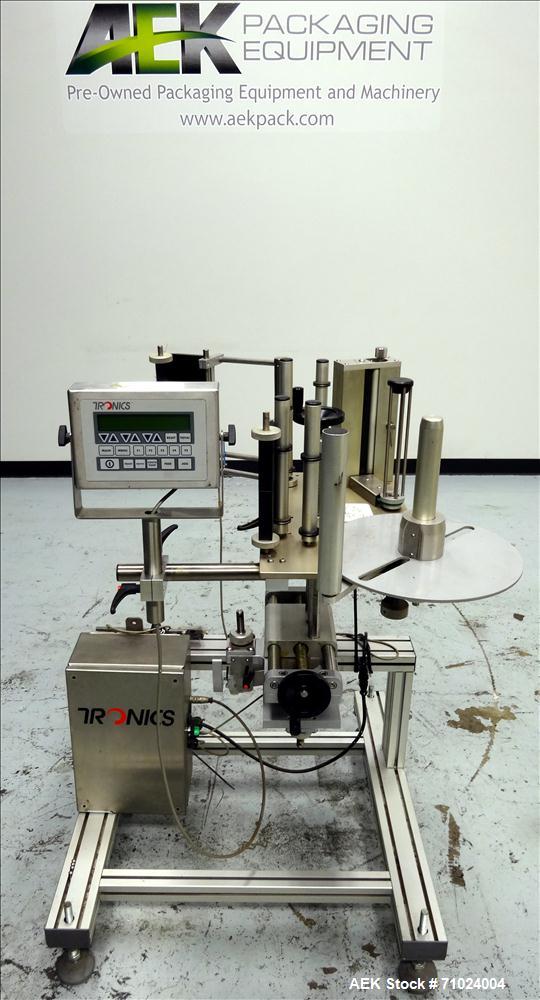 Used Tronics Model S1000 Stand Alone Pressure Sensitive Labeler. Capable of speeds up 1,200" per minute. Has maximum label height of 8.5". Equipped with 9.5" peel plate, tronics hmi, and label sensor...