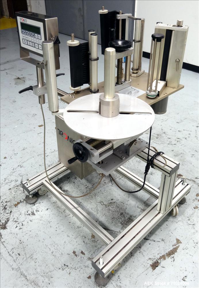 Used Tronics Model S1000 Stand Alone Pressure Sensitive Labeler. Capable of speeds up 1,200" per minute. Has maximum label height of 8.5". Equipped with 9.5" peel plate, tronics hmi, and label sensor...