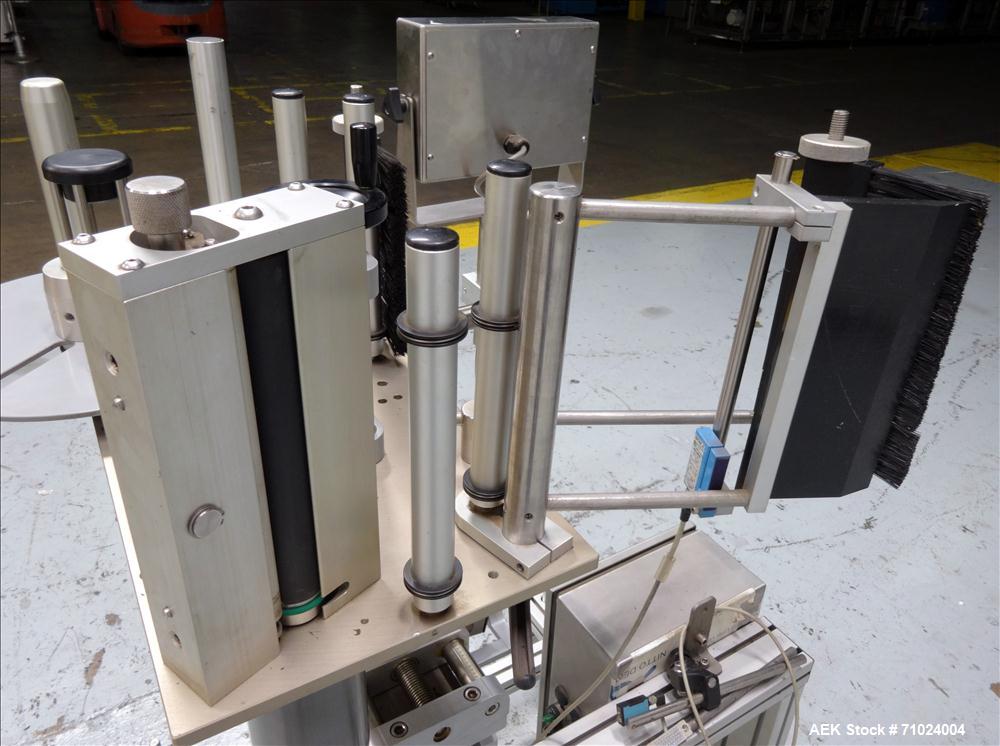 Used Tronics Model S1000 Stand Alone Pressure Sensitive Labeler. Capable of speeds up 1,200" per minute. Has maximum label height of 8.5". Equipped with 9.5" peel plate, tronics hmi, and label sensor...
