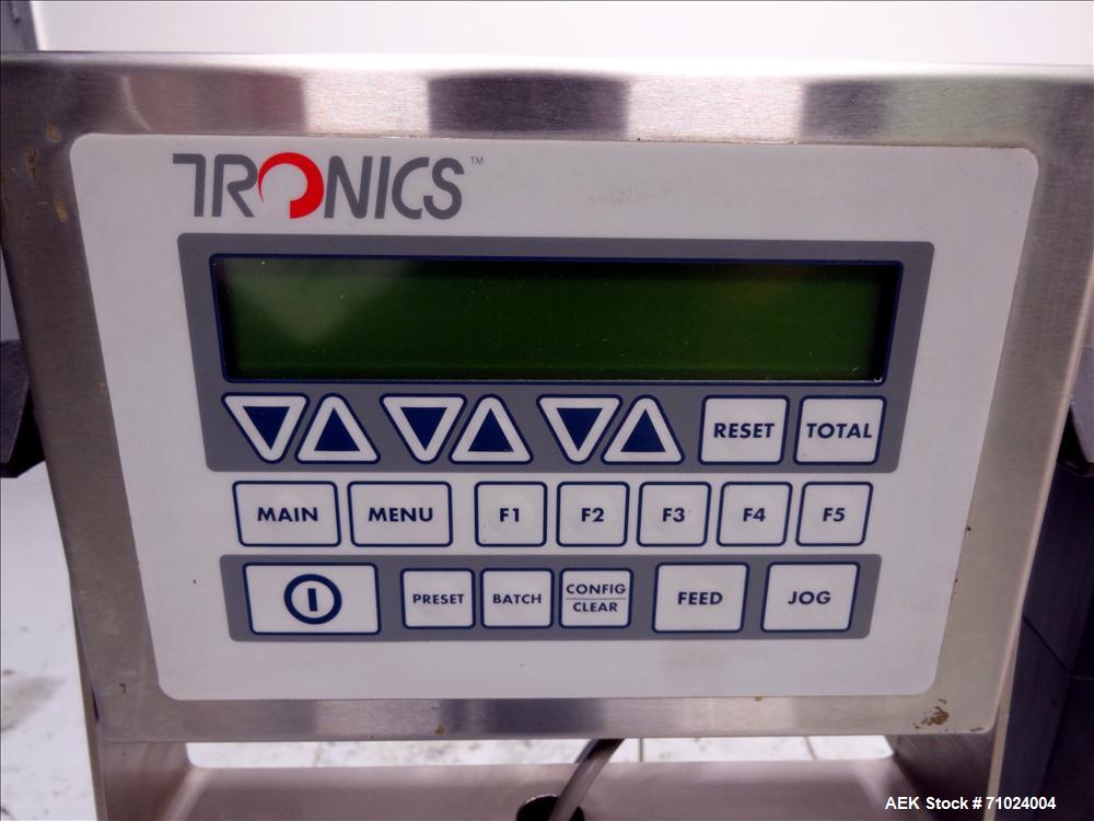 Used Tronics Model S1000 Stand Alone Pressure Sensitive Labeler. Capable of speeds up 1,200" per minute. Has maximum label height of 8.5". Equipped with 9.5" peel plate, tronics hmi, and label sensor...