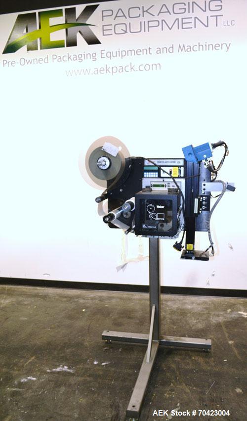 Used Weber Marking Systems Series 5200 Label Printer Applicator Model 5200V2. Label roll size maximum 12" diameter. Includes a Zebra 170 PAX4 print engine. 1/60/115 volt, 5 amp. Mounted on a frame.