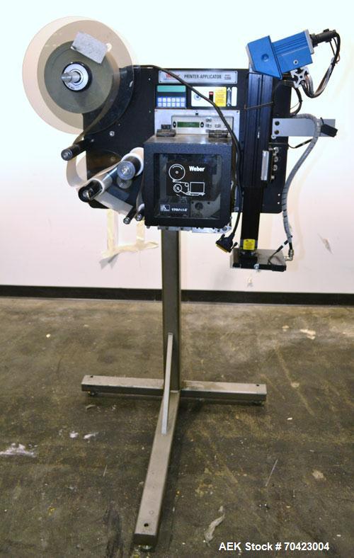 Used Weber Marking Systems Series 5200 Label Printer Applicator Model 5200V2. Label roll size maximum 12" diameter. Includes a Zebra 170 PAX4 print engine. 1/60/115 volt, 5 amp. Mounted on a frame.