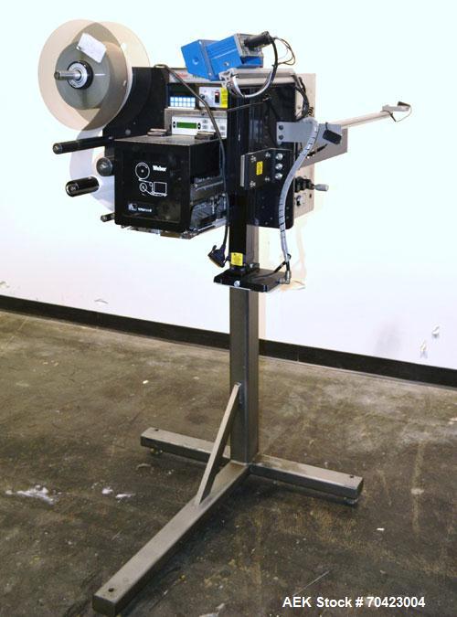 Used Weber Marking Systems Series 5200 Label Printer Applicator Model 5200V2. Label roll size maximum 12" diameter. Includes a Zebra 170 PAX4 print engine. 1/60/115 volt, 5 amp. Mounted on a frame.