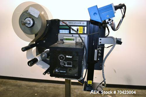 Used Weber Marking Systems Series 5200 Label Printer Applicator Model 5200V2. Label roll size maximum 12" diameter. Includes a Zebra 170 PAX4 print engine. 1/60/115 volt, 5 amp. Mounted on a frame.