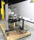 Used Paragon Model PLS-400 Print & Apply Case Labeler. Designed to print barcode and RFID labels. Machine has a 7” Tall label head. Includes automatic belt type case conveyor, integrated on common fr...