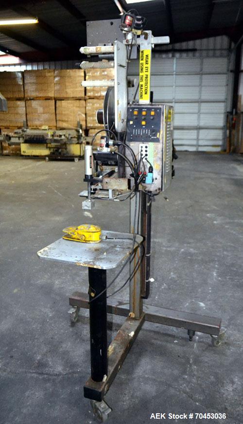 Used LSI Loose Loop Print & Apply Labeler, Model 1360, capable of 120 products per minute. Can accommodate up to 4" x 4" labels. Foot pedal controls. Mounted on a stand with casters. Missing printer....