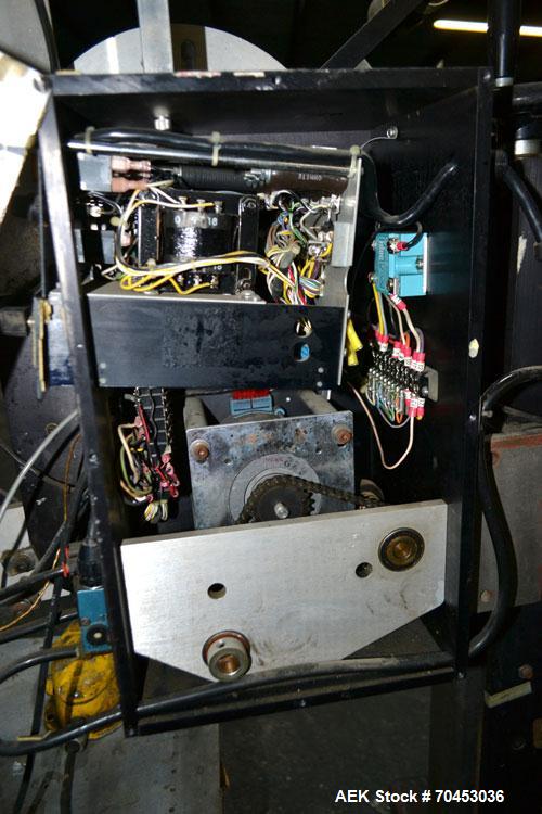 Used LSI Loose Loop Print & Apply Labeler, Model 1360, capable of 120 products per minute. Can accommodate up to 4" x 4" labels. Foot pedal controls. Mounted on a stand with casters. Missing printer....