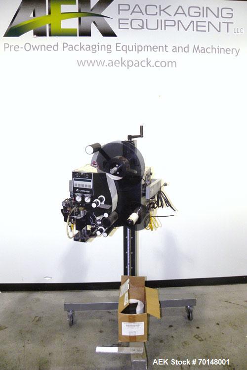 Used Label-Aire Model 2114 CDL High Speed Pressure Sensitive Spot Labeler. Machine is capable of speeds up to 1250 linear inches of web per minute. Has a label size range: length 3/4" to 5.5" or 19mm...