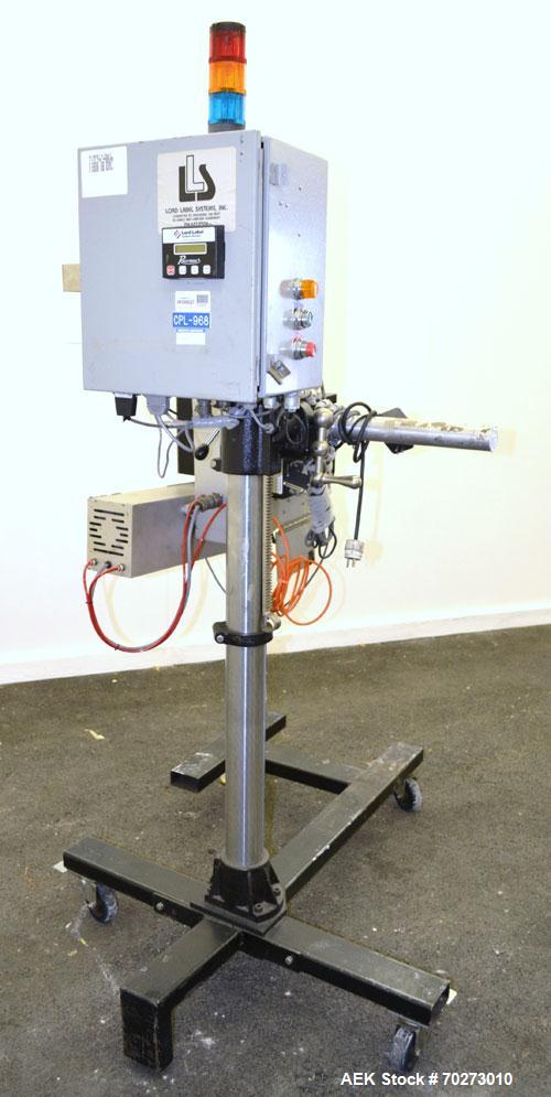 Used Lord Label Systems Print & Apply Portable Pressure Sensitive Labeler. Includes a Sato bar code printer, model M-8400S. Mounted on a stand with casters. Last placing labels on bundles of cartons.