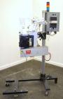 Used Lord Label Systems Print & Apply Portable Pressure Sensitive Labeler. Includes a Sato bar code printer, model M-8400S. Mounted on a stand with casters. Last placing labels on bundles of cartons.