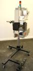 Used Lord Label Systems Print & Apply Portable Pressure Sensitive Labeler. Includes a Sato bar code printer, model M-8400S. Mounted on a stand with casters. Last placing labels on bundles of cartons.