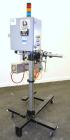 Used Lord Label Systems Print & Apply Portable Pressure Sensitive Labeler. Includes a Sato bar code printer, model M-8400S. Mounted on a stand with casters. Last placing labels on bundles of cartons.