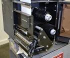 Used Lord Label Systems Print & Apply Portable Pressure Sensitive Labeler. Includes a Sato bar code printer, model M-8400S. Mounted on a stand with casters. Last placing labels on bundles of cartons.