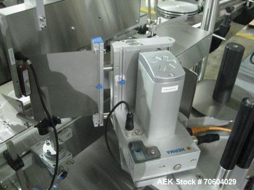 Used One (1) used Aesus wrap around labeler, model Premier Panel 362P, Herma label head, vision system, side bump belts, top hold down belt, reject and controls, 1/60/208 volt,